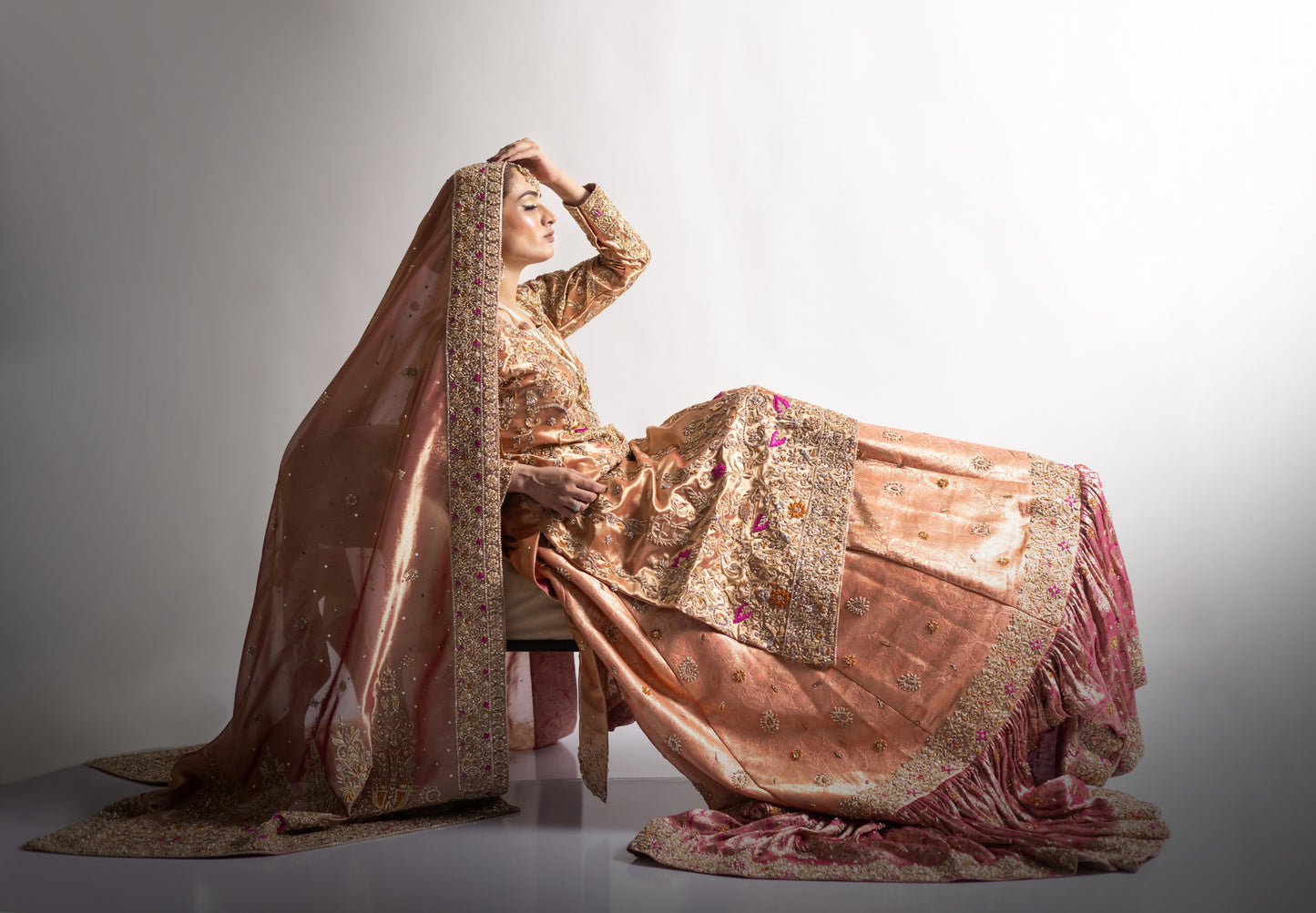 Afsheen bridal outfit by MariamRaj: Peach gold or magenta pink tissue silk Pishwas, Jamawar Gharara, delicate tissue dupatta, zardoze and resham embroidery for weddings