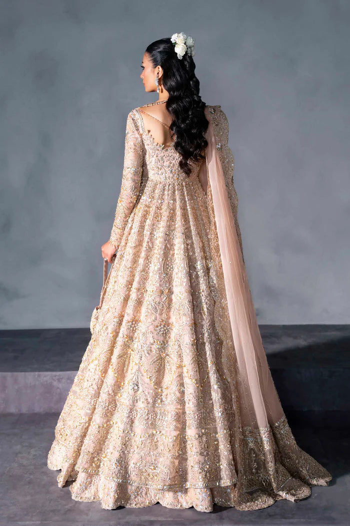 Blush pink bridal gown with criss-cross neckline, full sleeves, and mirror embellishments – perfect for South Asian brides in Canada, UAE, and abroad.