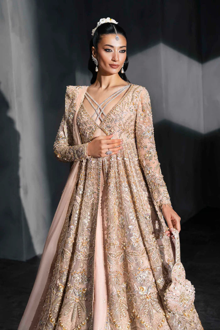 Blush pink bridal gown with criss-cross neckline, full sleeves, and mirror embellishments – perfect for South Asian brides in Canada, UAE, and abroad.
