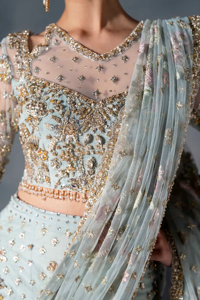 Powder blue bridal lehenga with gold embroidery, sheer sleeves, and pastel net dupatta – perfect for modern South Asian brides in USA, UK, Canada, and UAE.