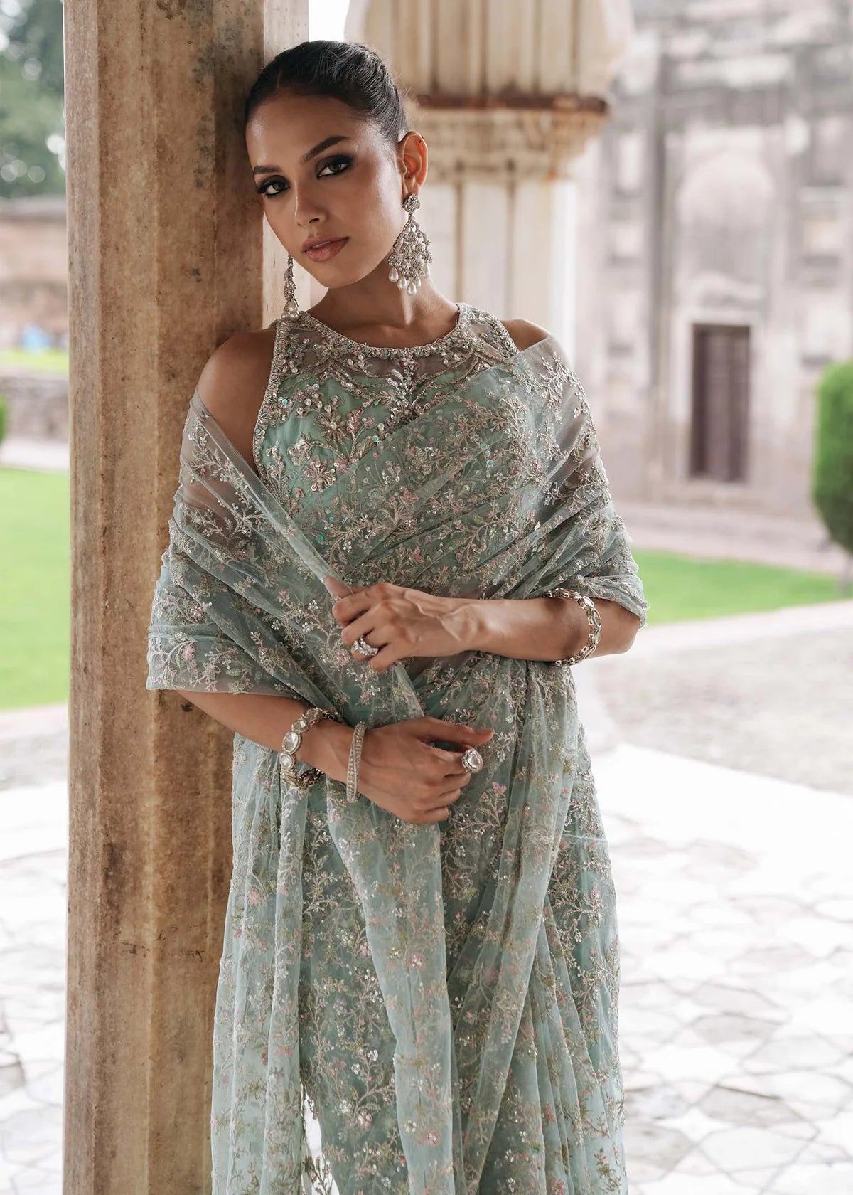 GUL E JAANA – Powder blue net saree with embroidery, raw silk petticoat, and embellished blouse. Stitched wedding saree online at Pakistanimoda.