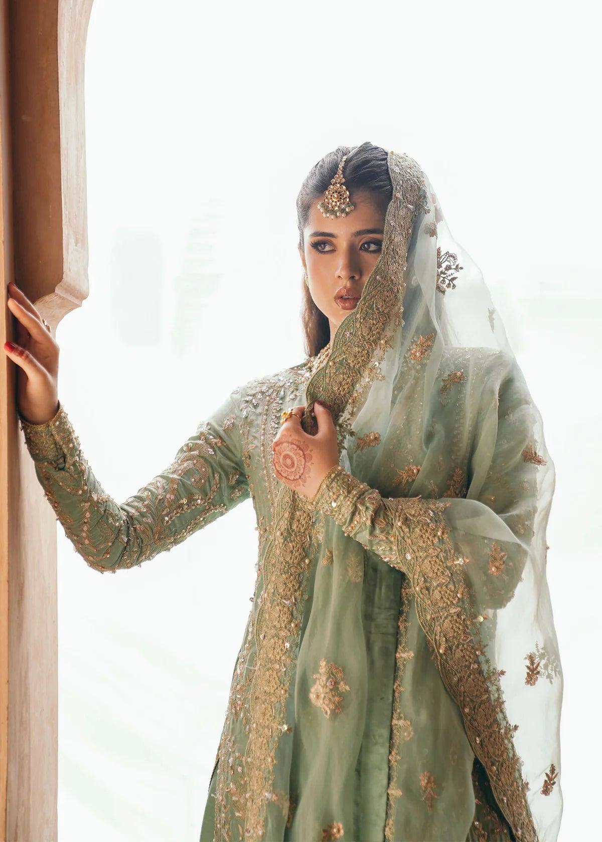Kaneez aqua front-open three-piece silk party wear suit with flared pants and embroidered organza dupatta by Kanwal Malik, ideal for festive occasions.