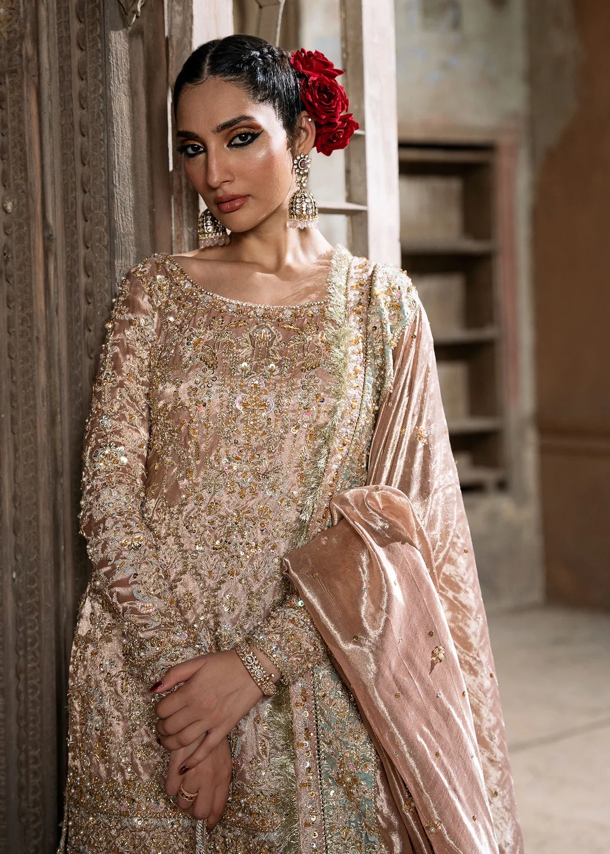 Meeram pink bridal gharara outfit with tissue dupatta and hand embellishments by Kanwal Malik, featuring pearl and sequin work.