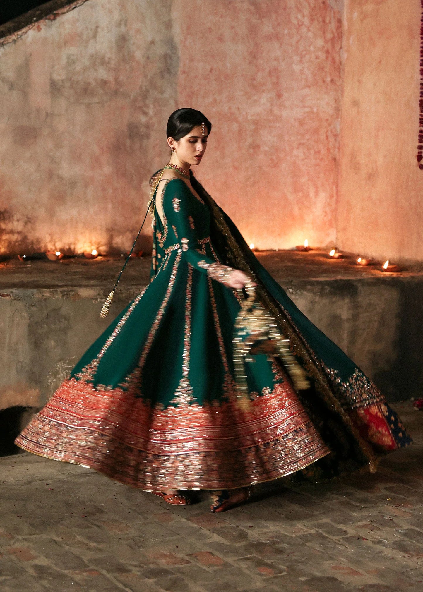 Emerald green raw silk embroidered pishwas with multicolored borders, paired with churidar and embroidered shawl – Hussain Rehar Festive ’25 at Pakistanimoda.