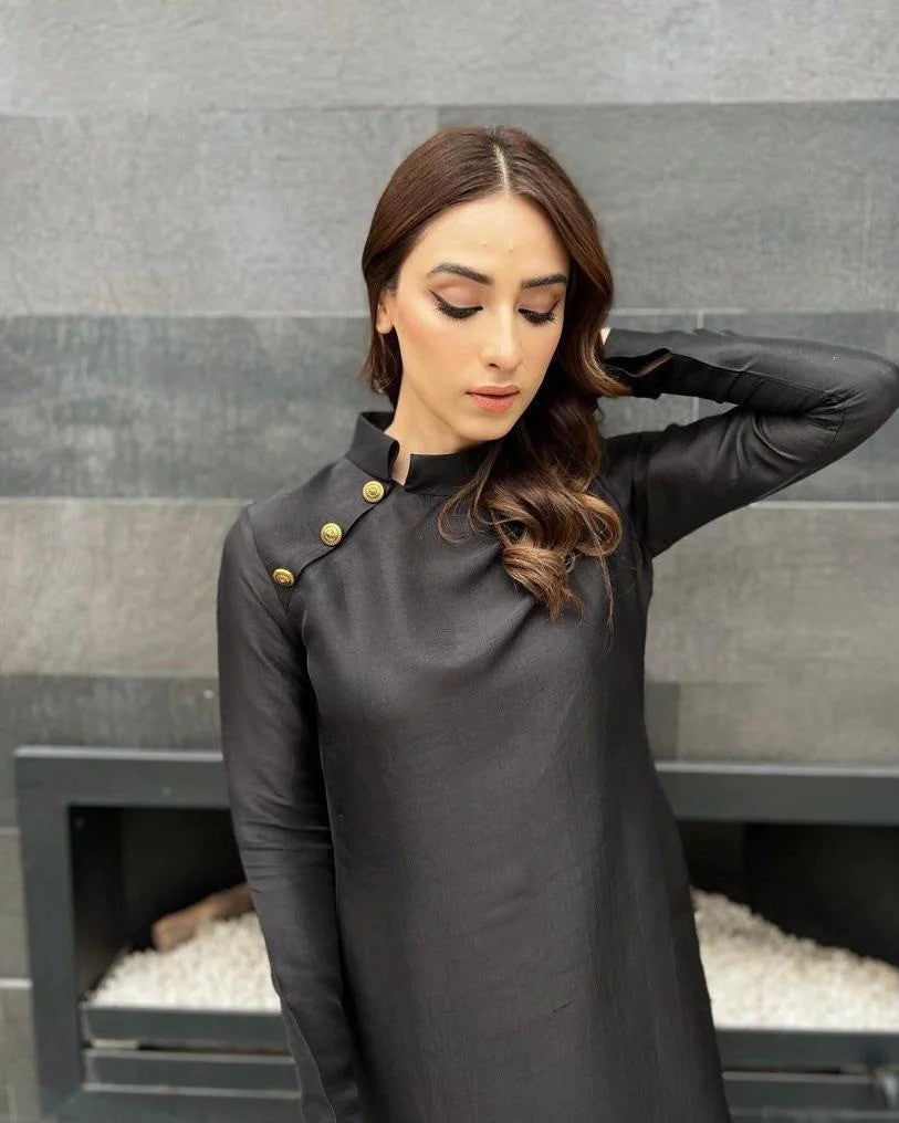 black long shirt dress pakistani A statement black long shirt with fine golden detailing, finished with a bordered dupatta and sleek fused trousers. black tessel silk dress, black formal dress Pakistan, golden handwork dress, luxury black outfit,