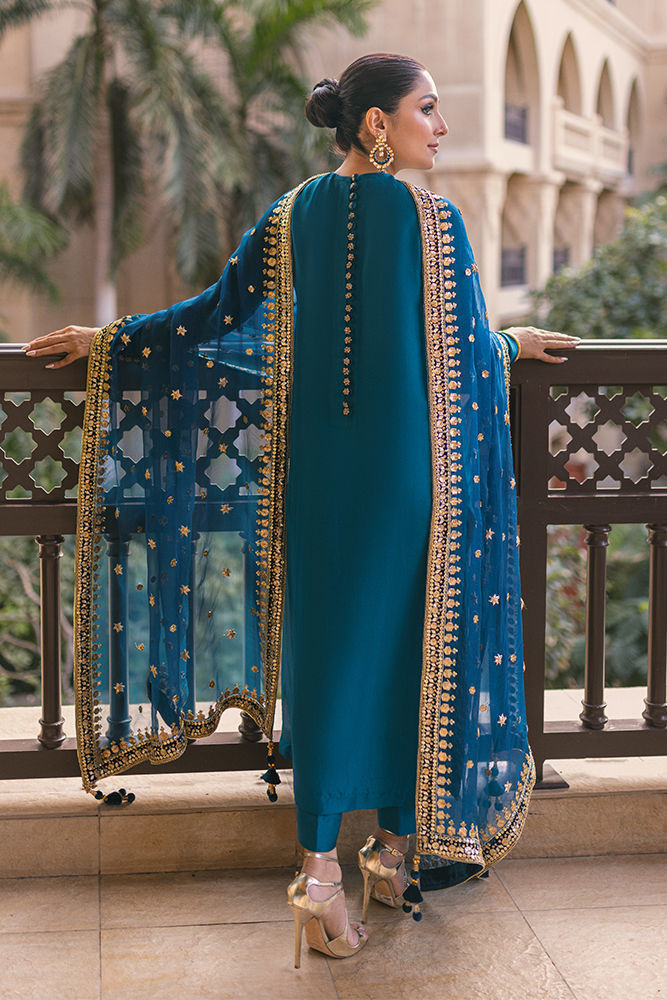 Sapphire blue Pakistani silk dress with back handwork buttons, churidar pants, and a gota embellished dupatta – ideal for weddings and formal events.