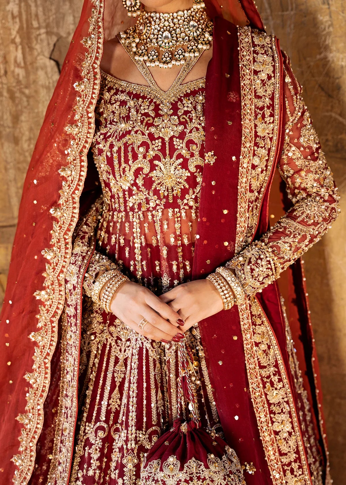 Shirin red stitched bridal pishwas and lehenga by Kanwal Malik with hand embellishments, paired with dual organza dupattas for wedding and festive events.