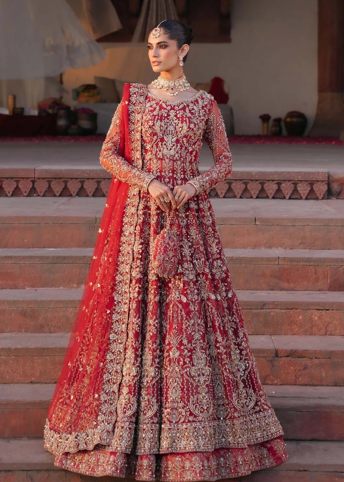 ARMAL – Red bridal pishwas with hand embroidery, Korean silk lehenga, and net dupatta. Stitched Pakistani bridal outfit online at Pakistanimoda.