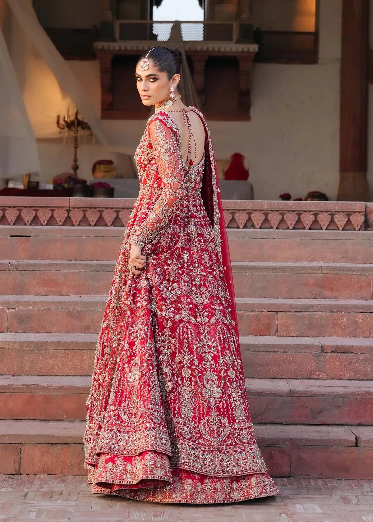 ARMAL – Red bridal pishwas with hand embroidery, Korean silk lehenga, and net dupatta. Stitched Pakistani bridal outfit online at Pakistanimoda.