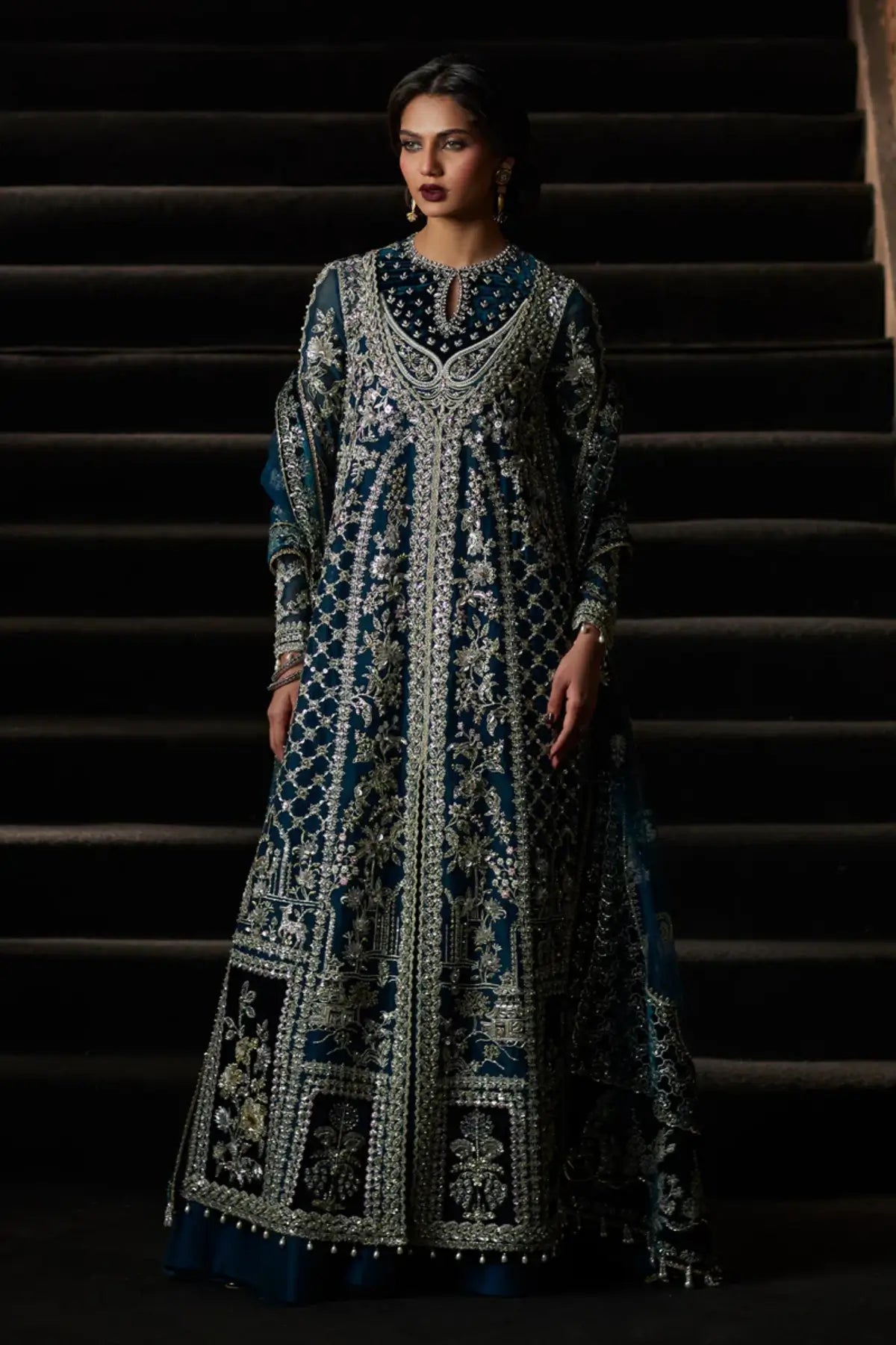 Alira deep teal front open gown formal suit by Saad Bin Shahzad with sharara and net dupatta featuring velvet borders