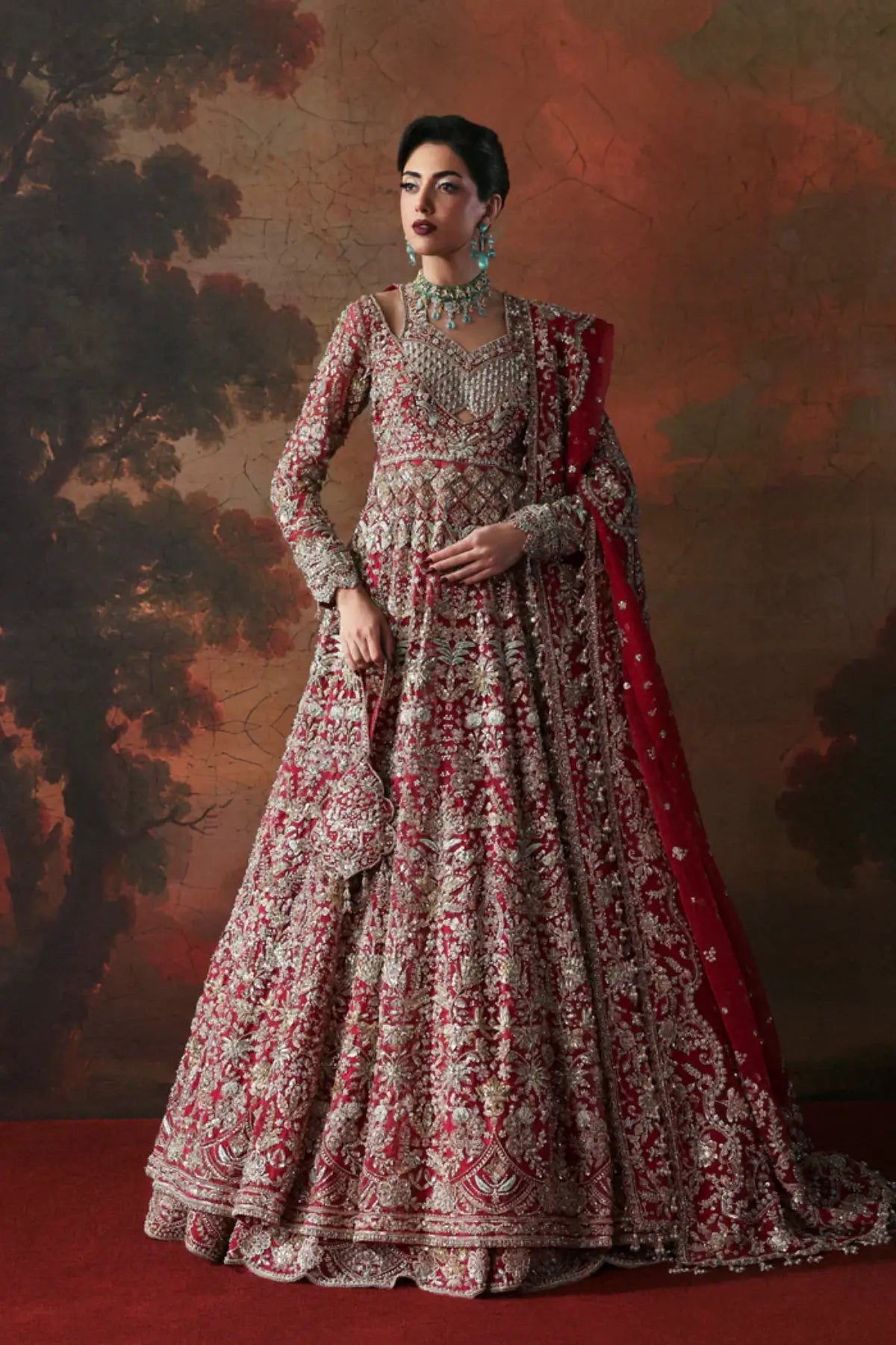Avena crimson red bridal stitched lehenga from Akbar Aslam Serena Bridal Edit '26 crafted in organza with silk inner.