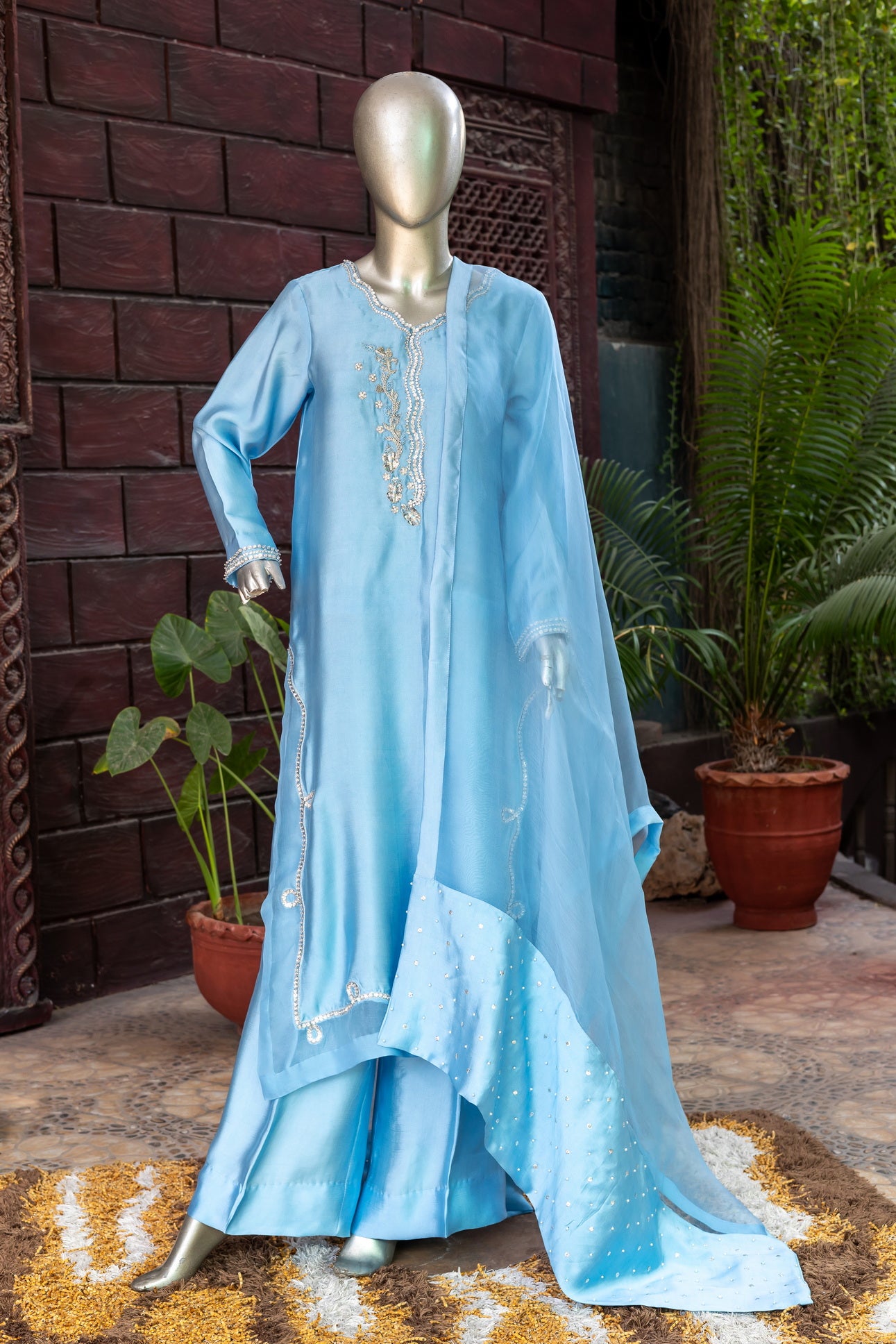 Sky blue Pakistani sheesha silk suit with vertical neckline embroidery, sleeve and side panel work, and pearl-detailed organza dupatta by MariamRaj for festive wear in the USA.