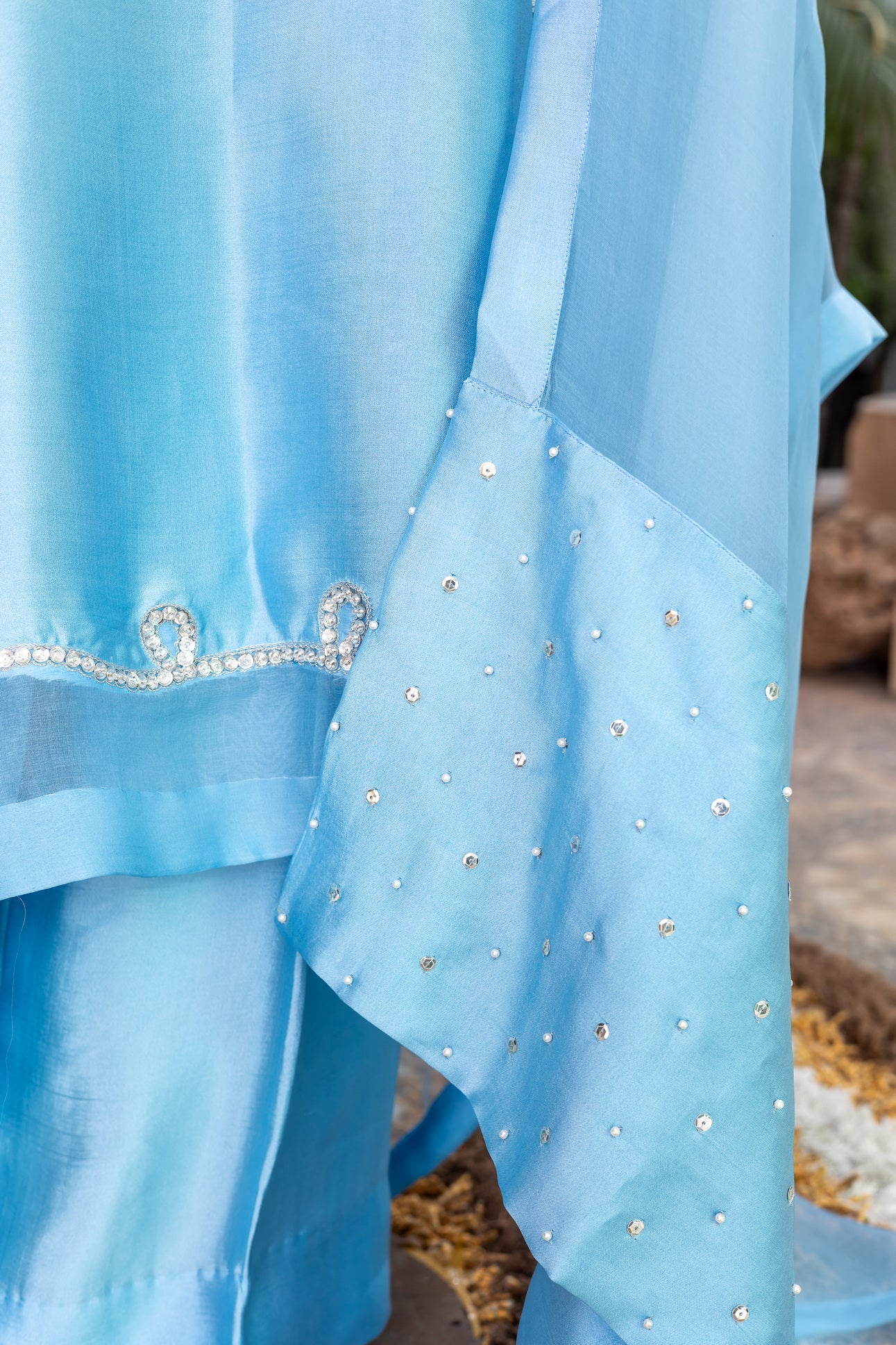 Sky blue Pakistani sheesha silk suit with vertical neckline embroidery, sleeve and side panel work, and pearl-detailed organza dupatta by MariamRaj for festive wear in the USA.