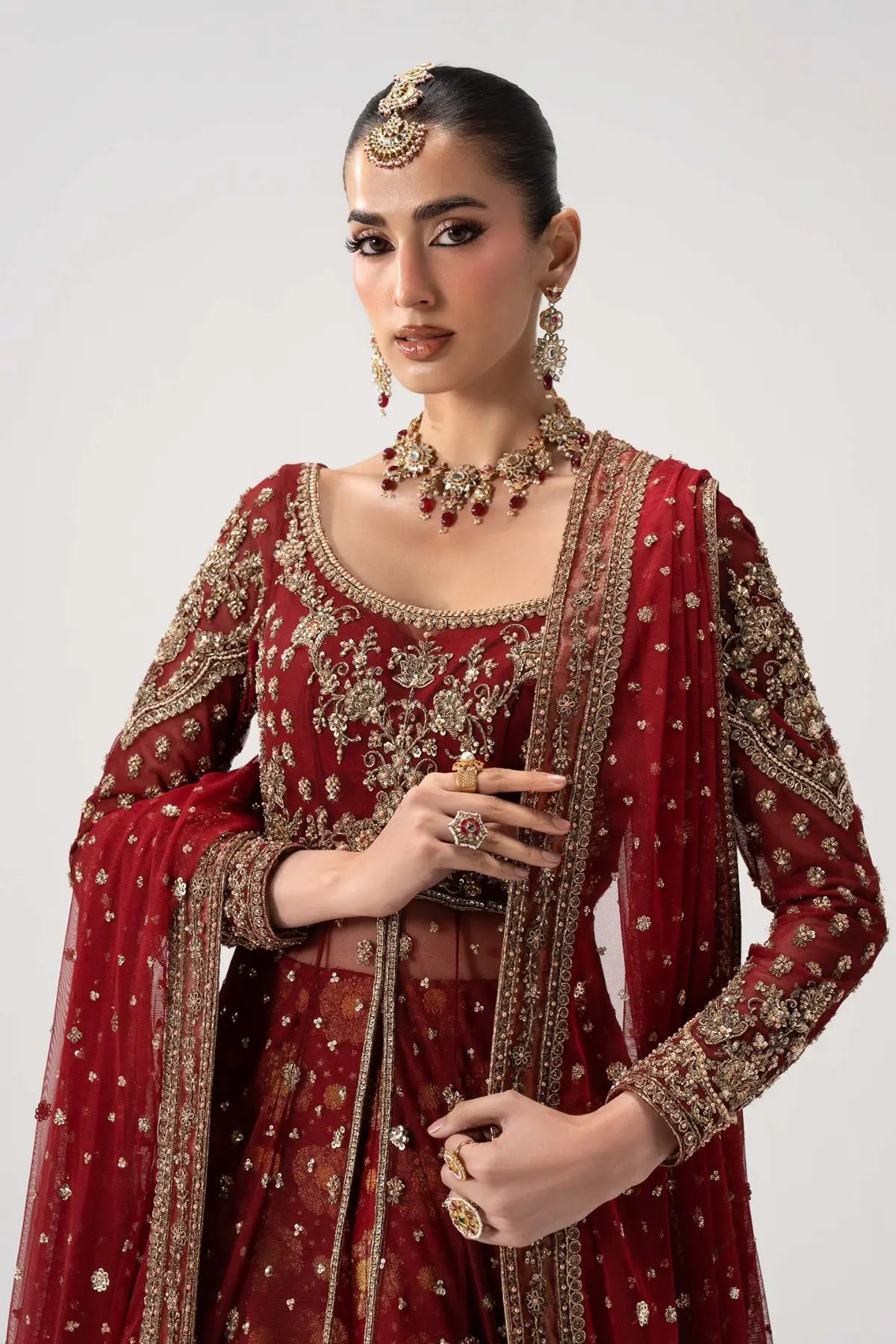 Bazif deep red royal bridal pishwas lehenga set with jamawar lehenga and net dupatta by Maria B