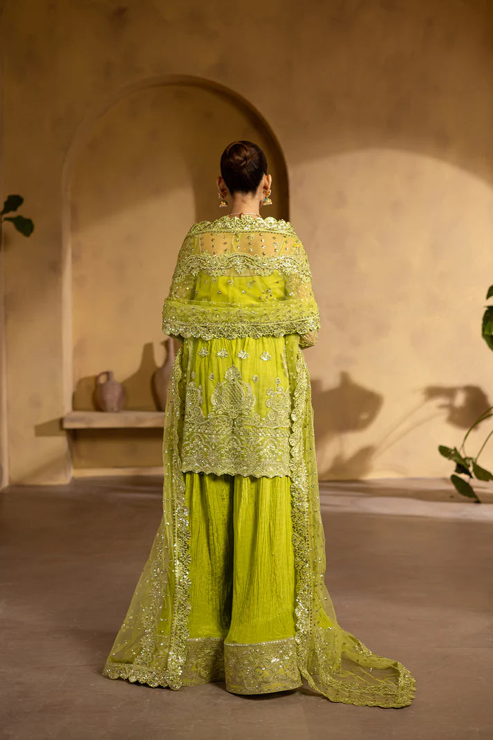 Lime yellow net dress with organza embroidery and raw silk trousers.
