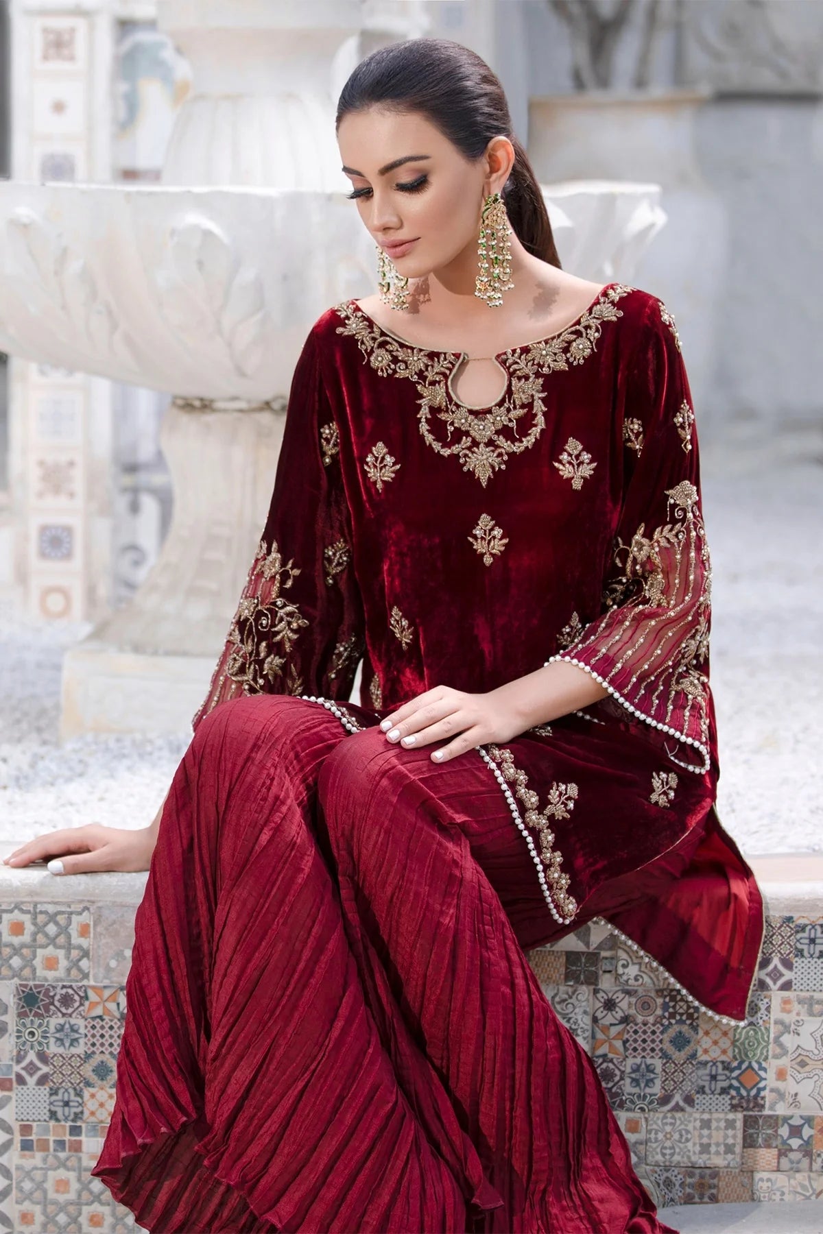 Maroon velvet shirt with dabka, cora, and pearl work, paired with crushed silk pants and matching organza dupatta – ideal for formal wear 2025.