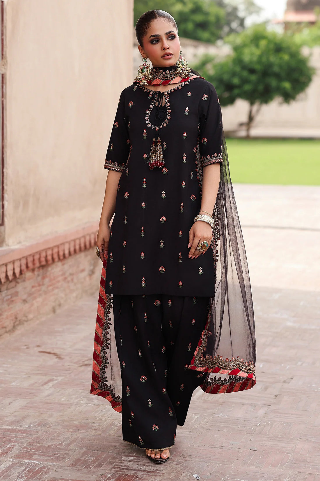 CMA-5-069 black raw silk embroidered Pakistani 3-piece formal suit with tassel neckline, embroidered shalwar, and poly net dupatta – shop online at Pakistanimoda.com.