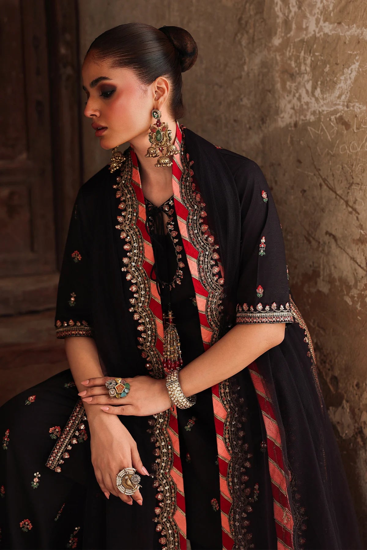 CMA-5-069 black raw silk embroidered Pakistani 3-piece formal suit with tassel neckline, embroidered shalwar, and poly net dupatta – shop online at Pakistanimoda.com.