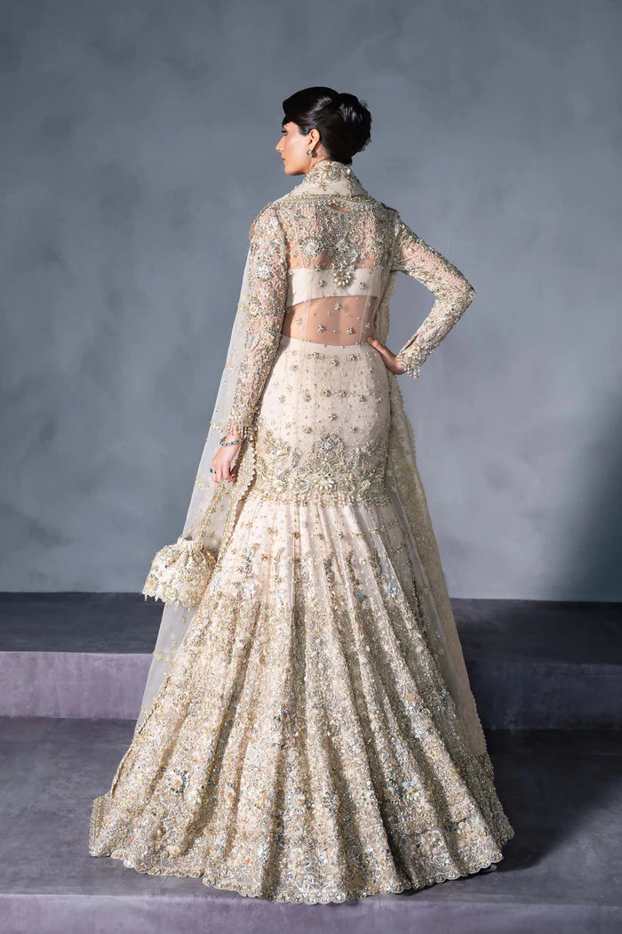 Luxury gold Pakistani bridal lehenga with hand embroidery, crystals, full sleeves, scalloped dupatta, and pouch – perfect for brides in USA, UK, Canada, and UAE.
