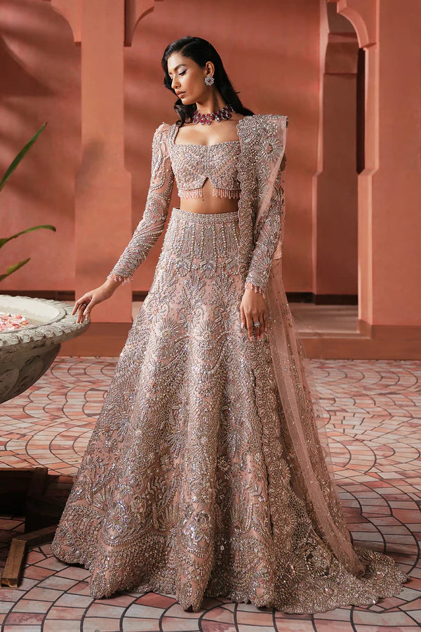 Elegant pink Pakistani bridal outfit for UK weddings, featuring a soft net lehenga and dupatta, hand-embellished with crystals, dabka, katdana, and traditional mukesh detailing.