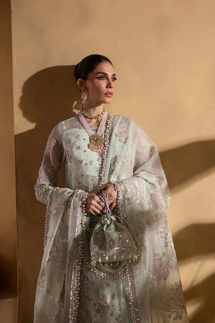 Sage green organza embroidered suit with silk trousers and pouch.