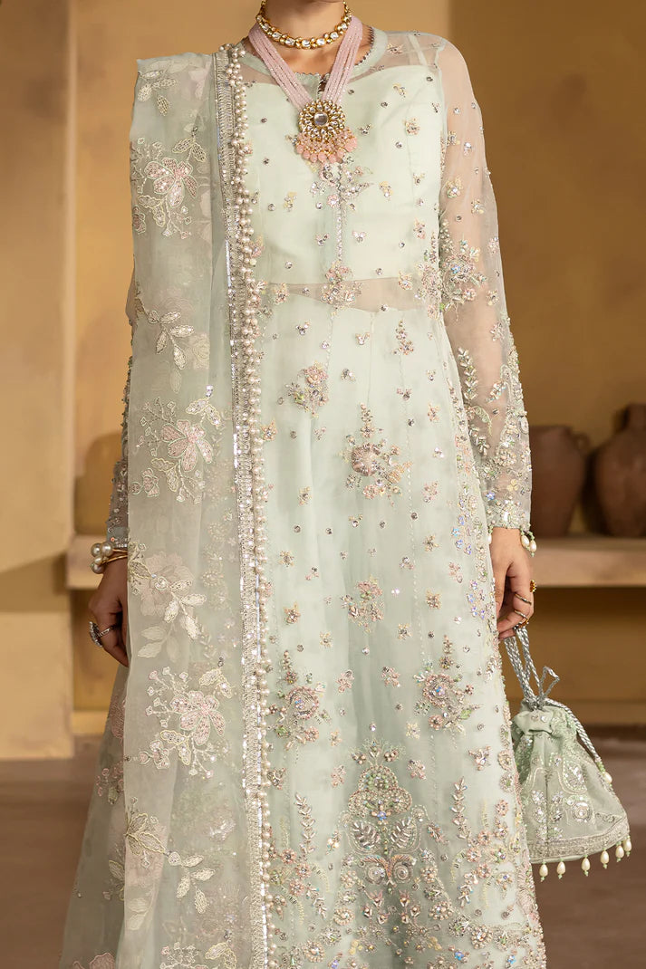 Sage green organza embroidered suit with silk trousers and pouch.