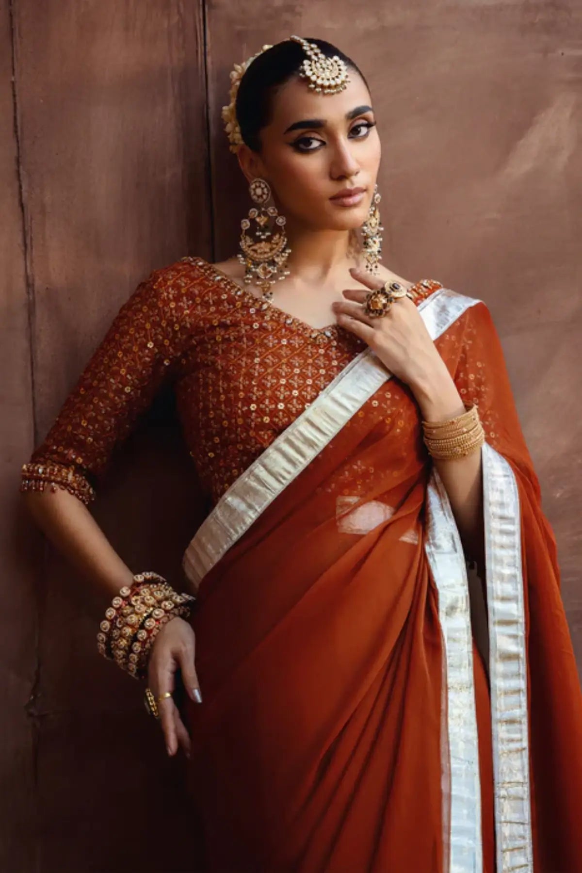 Coreene rust orange embroidered chiffon saree with blouse for wedding and festive wear