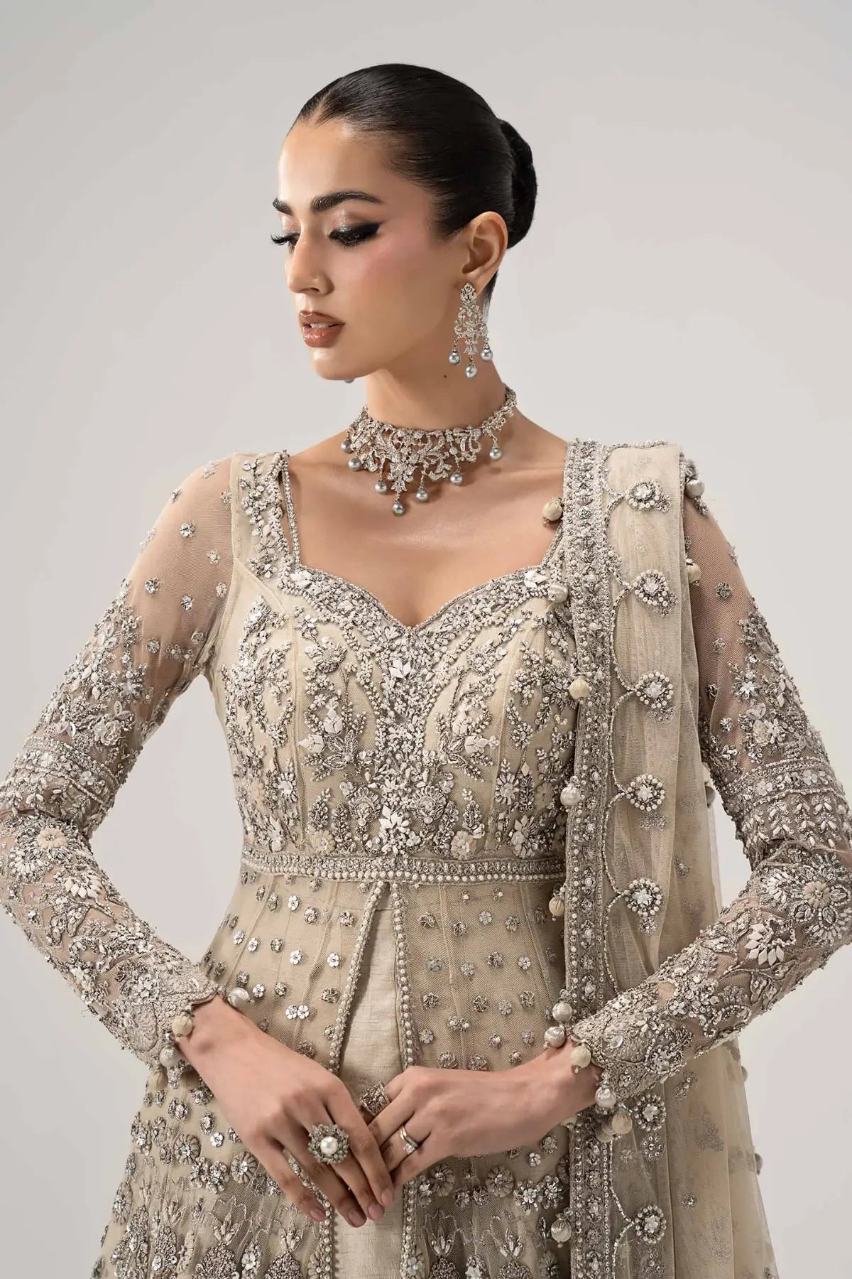 Elaria ivory embellished bridal gown by Maria B with net dupatta, pearl detailing and raw silk frock