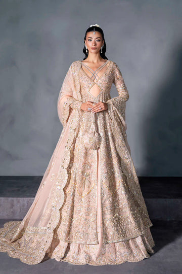 Blush pink bridal gown with criss-cross neckline, full sleeves, and mirror embellishments – perfect for South Asian brides in Canada, UAE, and abroad.

