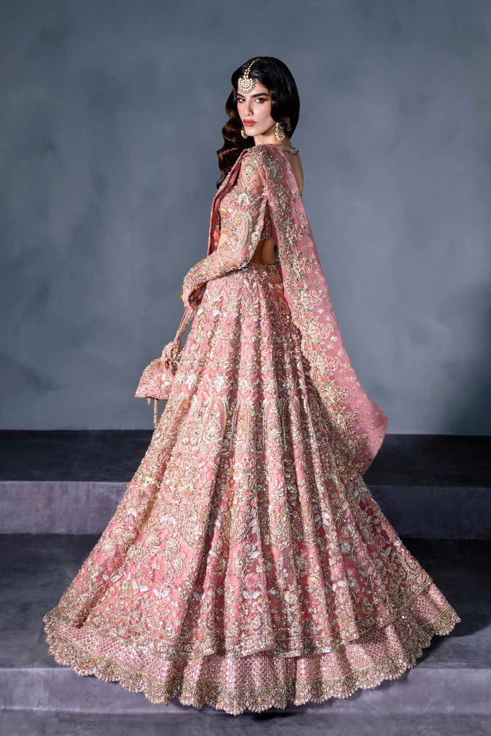 Blush pink Pakistani bridal lehenga with full sleeves, sheer dupatta, and handcrafted pouch – perfect for Desi brides in the USA, UK, Canada, and UAE.
