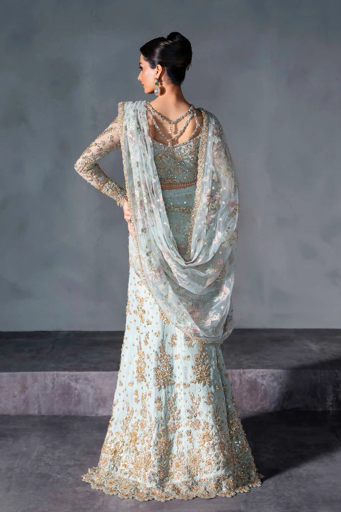 Powder blue bridal lehenga with gold embroidery, sheer sleeves, and pastel net dupatta – perfect for modern South Asian brides in USA, UK, Canada, and UAE.