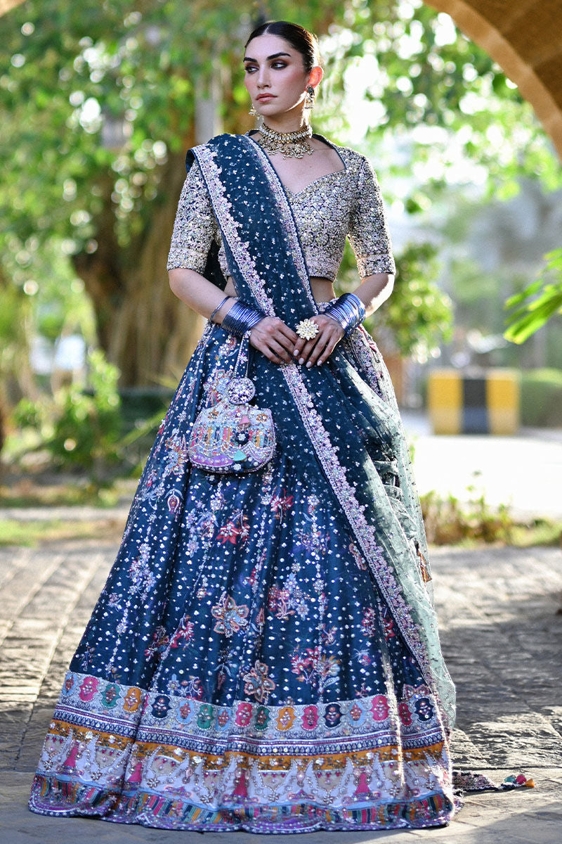 Teal printed Pakistani bridal lehenga choli with sweetheart neckline, geometric embellishments, and appliquéd net dupatta – perfect for brides in UK and Canada.