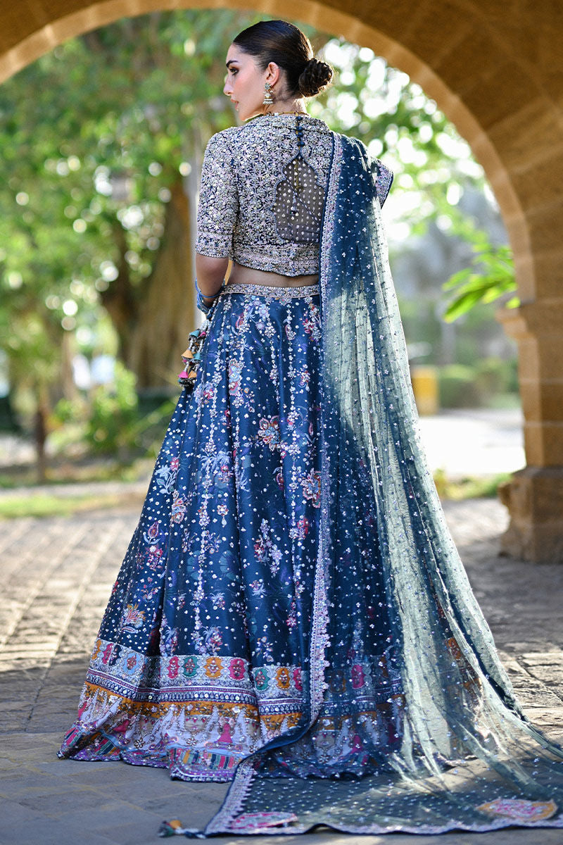 Teal printed Pakistani bridal lehenga choli with sweetheart neckline, geometric embellishments, and appliquéd net dupatta – perfect for brides in UK and Canada.