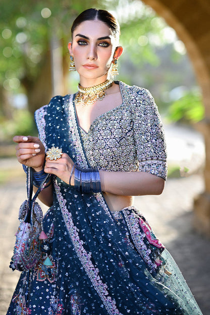 Teal printed Pakistani bridal lehenga choli with sweetheart neckline, geometric embellishments, and appliquéd net dupatta – perfect for brides in UK and Canada.