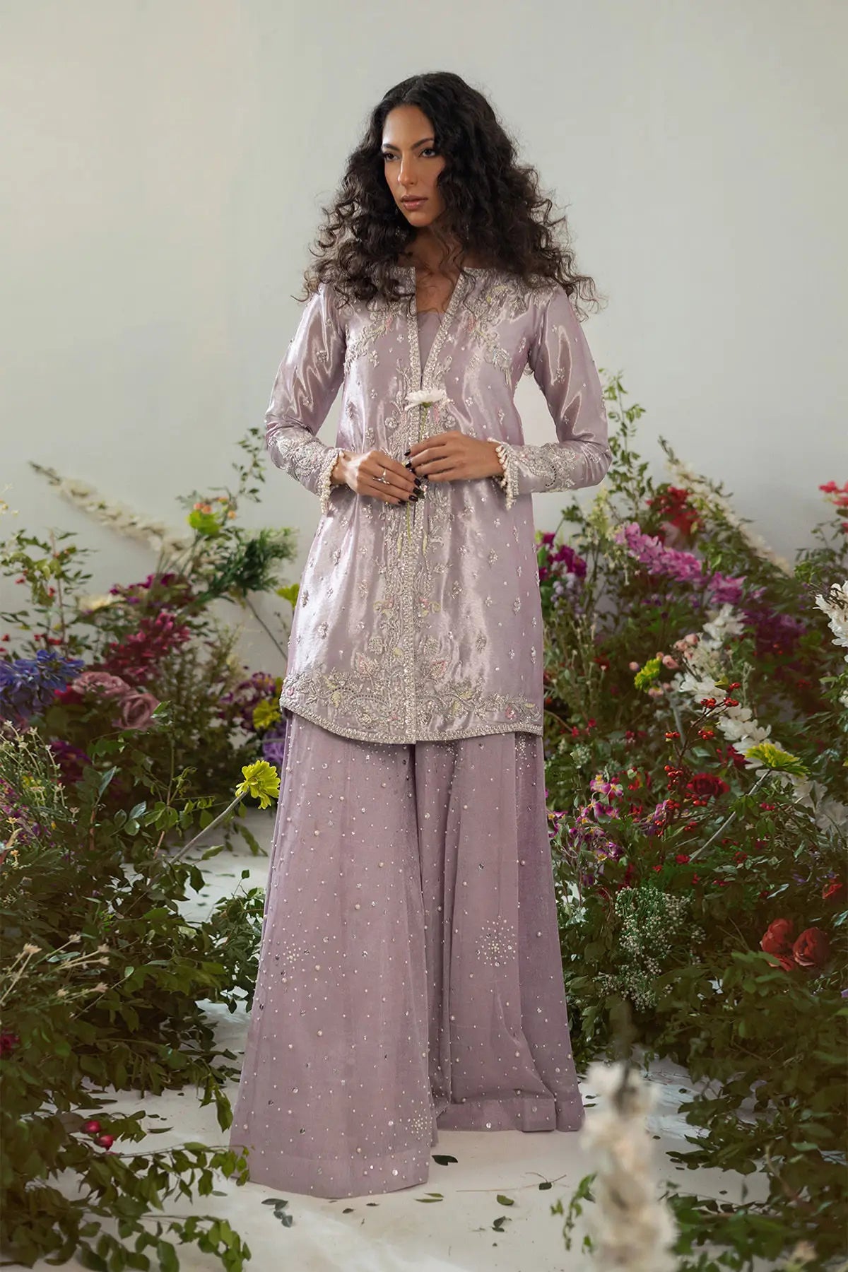 Elegant lilac lamé jacket set with zardozi and resham rosettes paired with flared pearl pants for special occasions