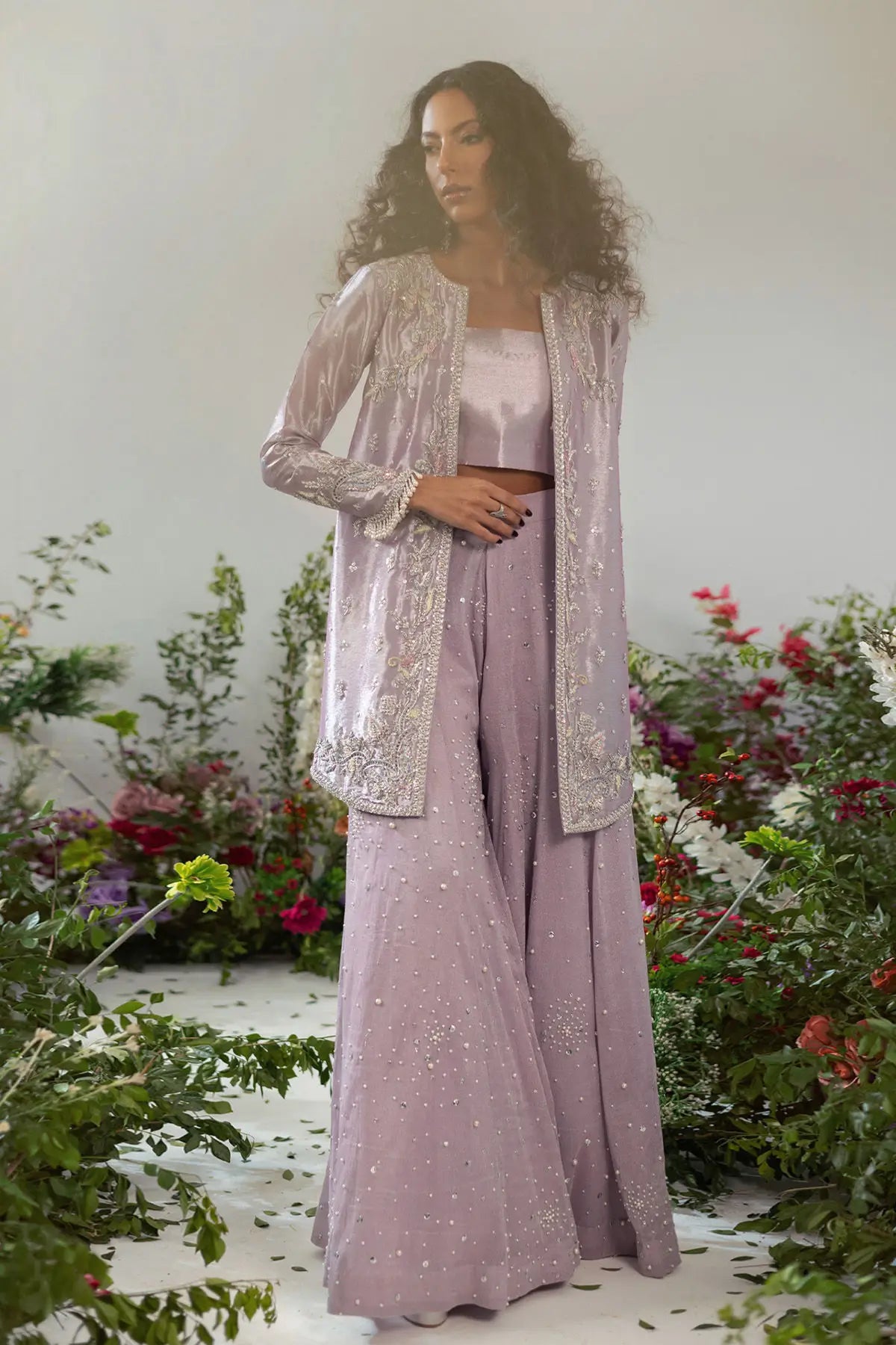 Elegant lilac lamé jacket set with zardozi and resham rosettes paired with flared pearl pants for special occasions