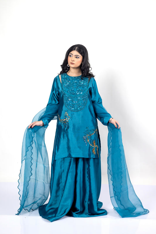 Faryal teal silk sharara set with sheesha silk shirt, flowing sharara, and organza dupatta with cutwork for evening events, dinner parties, and festive occasions by MariamRaj