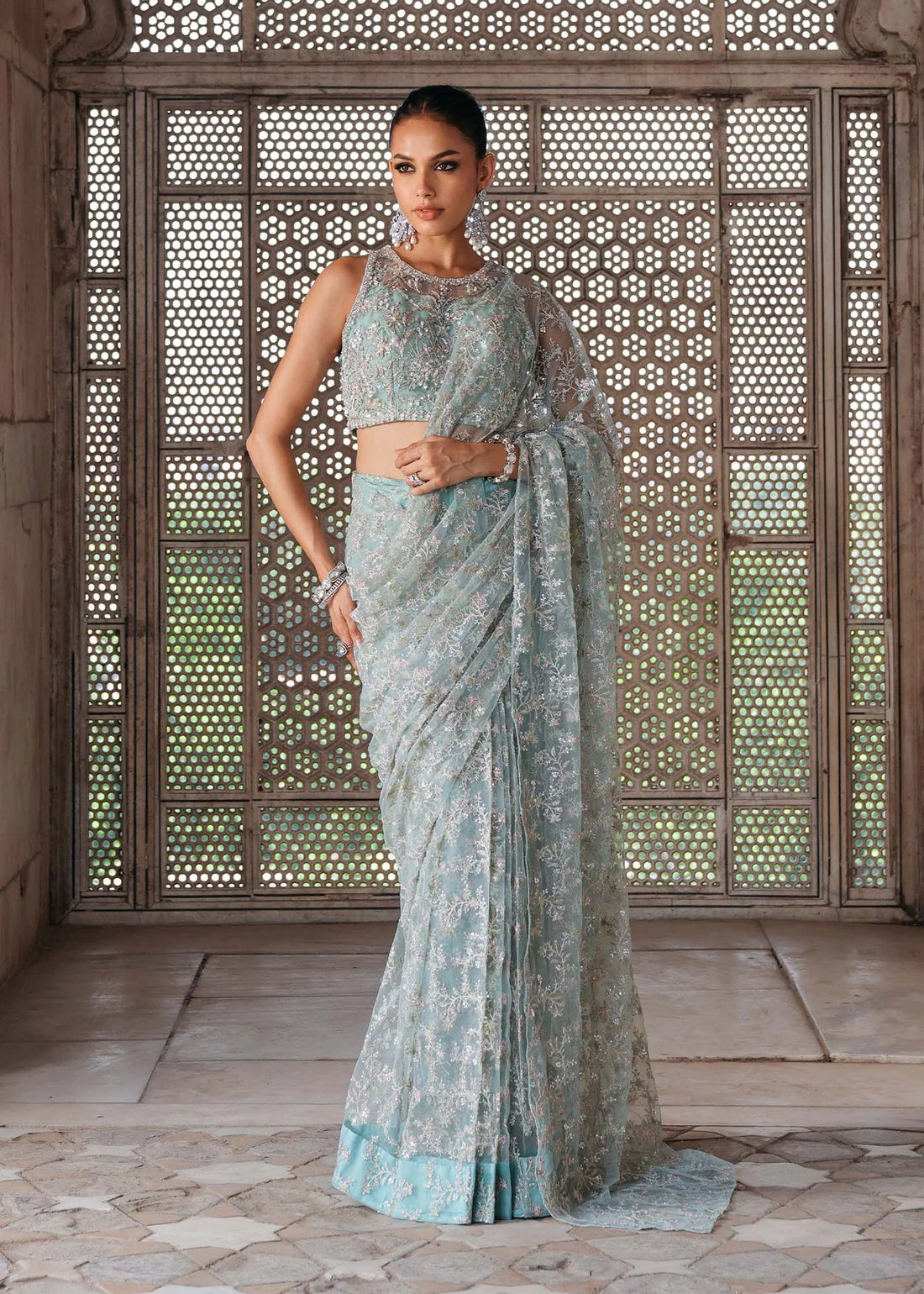 GUL E JAANA – Powder blue net saree with embroidery, raw silk petticoat, and embellished blouse. Stitched wedding saree online at Pakistanimoda.