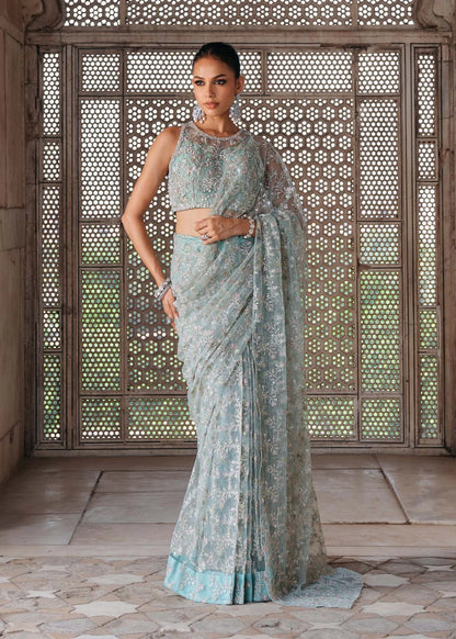GUL E JAANA – Powder blue net saree with embroidery, raw silk petticoat, and embellished blouse. Stitched wedding saree online at Pakistanimoda.