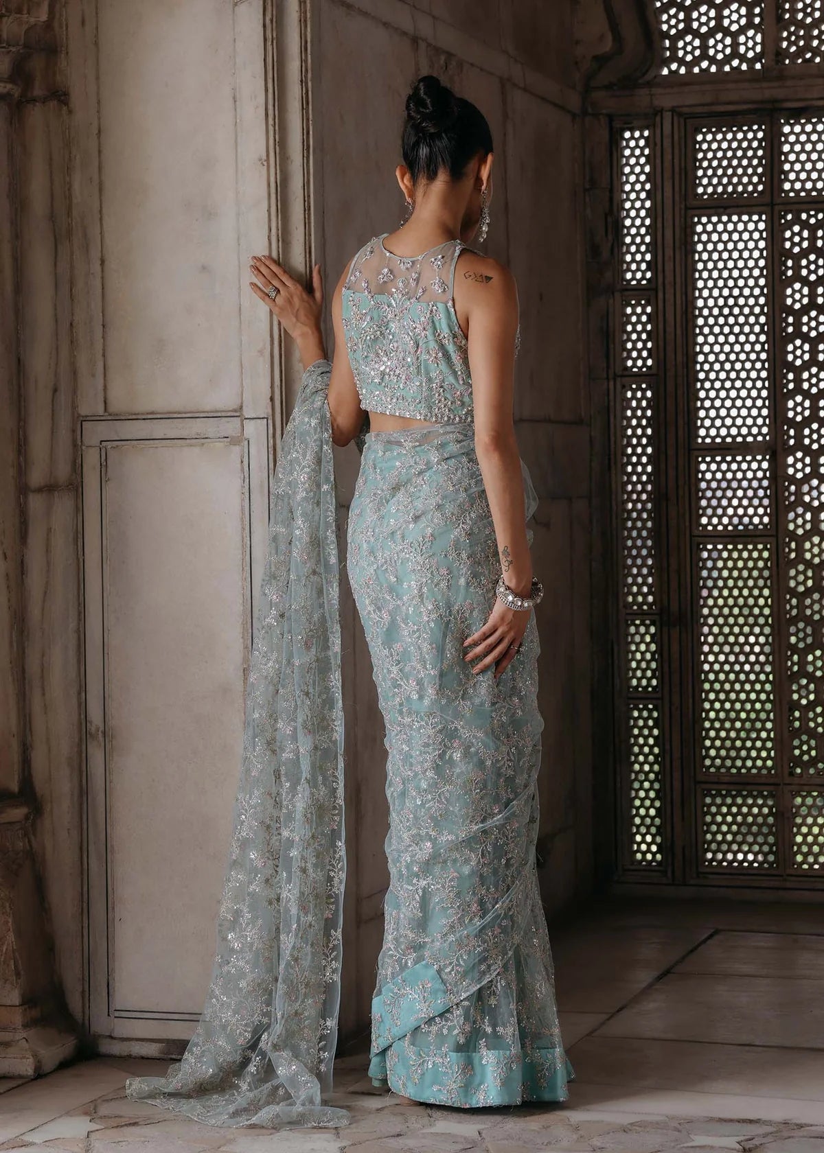 GUL E JAANA – Powder blue net saree with embroidery, raw silk petticoat, and embellished blouse. Stitched wedding saree online at Pakistanimoda.