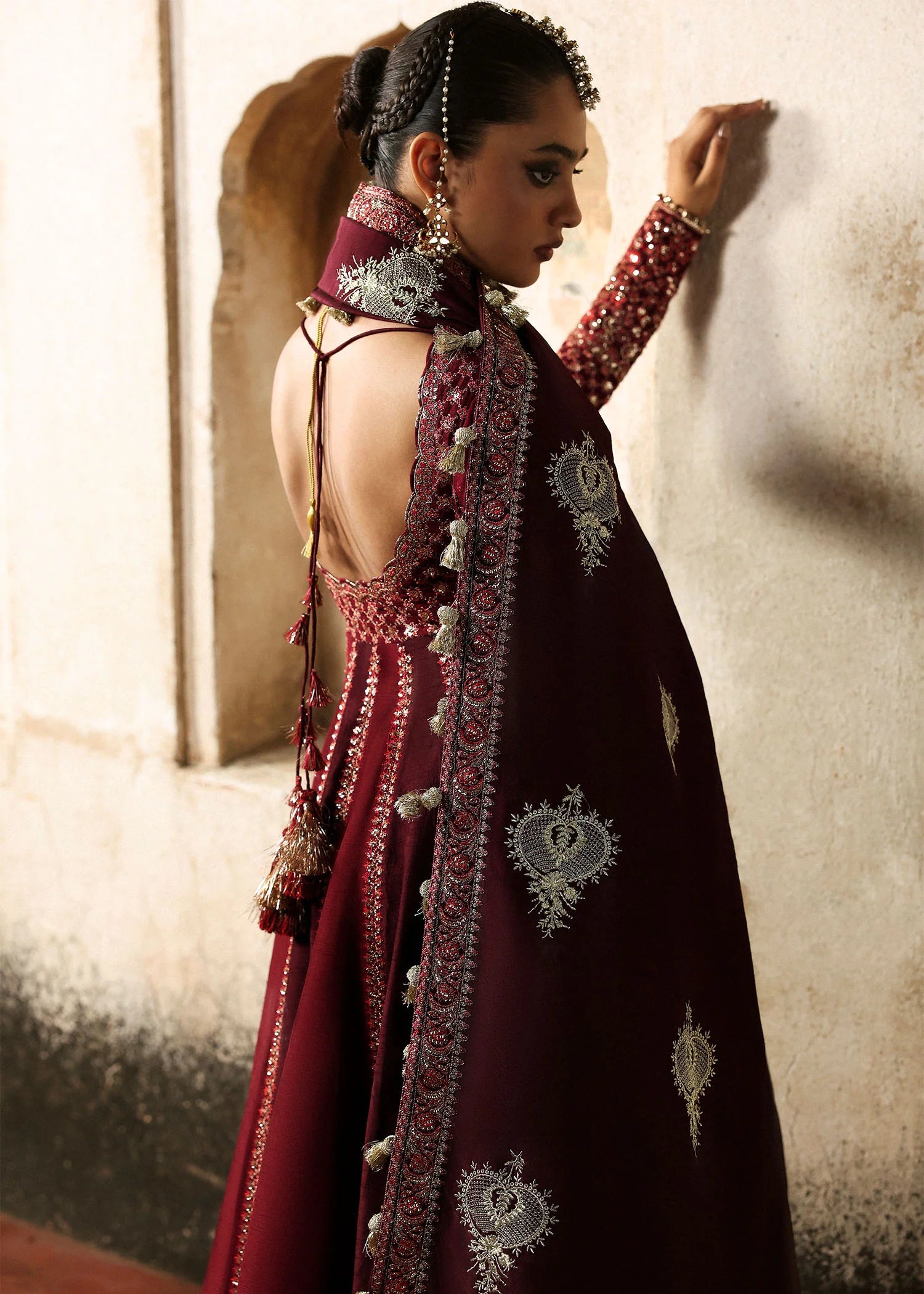 Model wearing Gulnar burgundy & maroon embroidered raw silk pishwas with churidar and shawl from Hussain Rehar Massarat Festive ’25 Collection.