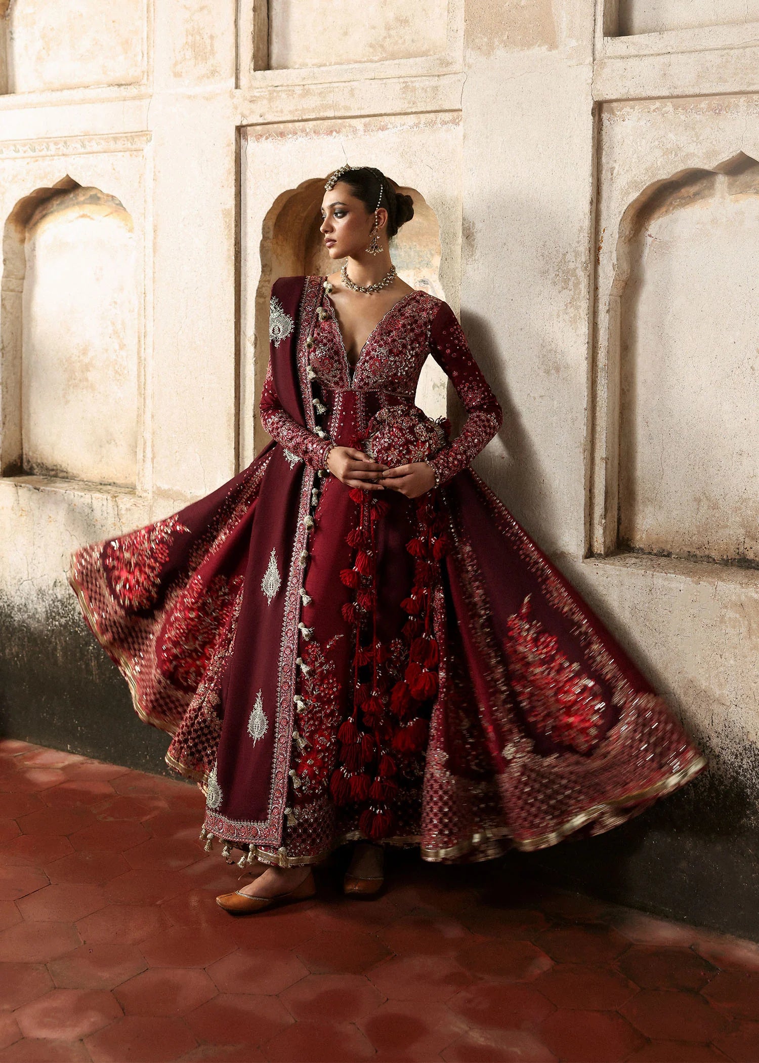 Model wearing Gulnar burgundy & maroon embroidered raw silk pishwas with churidar and shawl from Hussain Rehar Massarat Festive ’25 Collection.