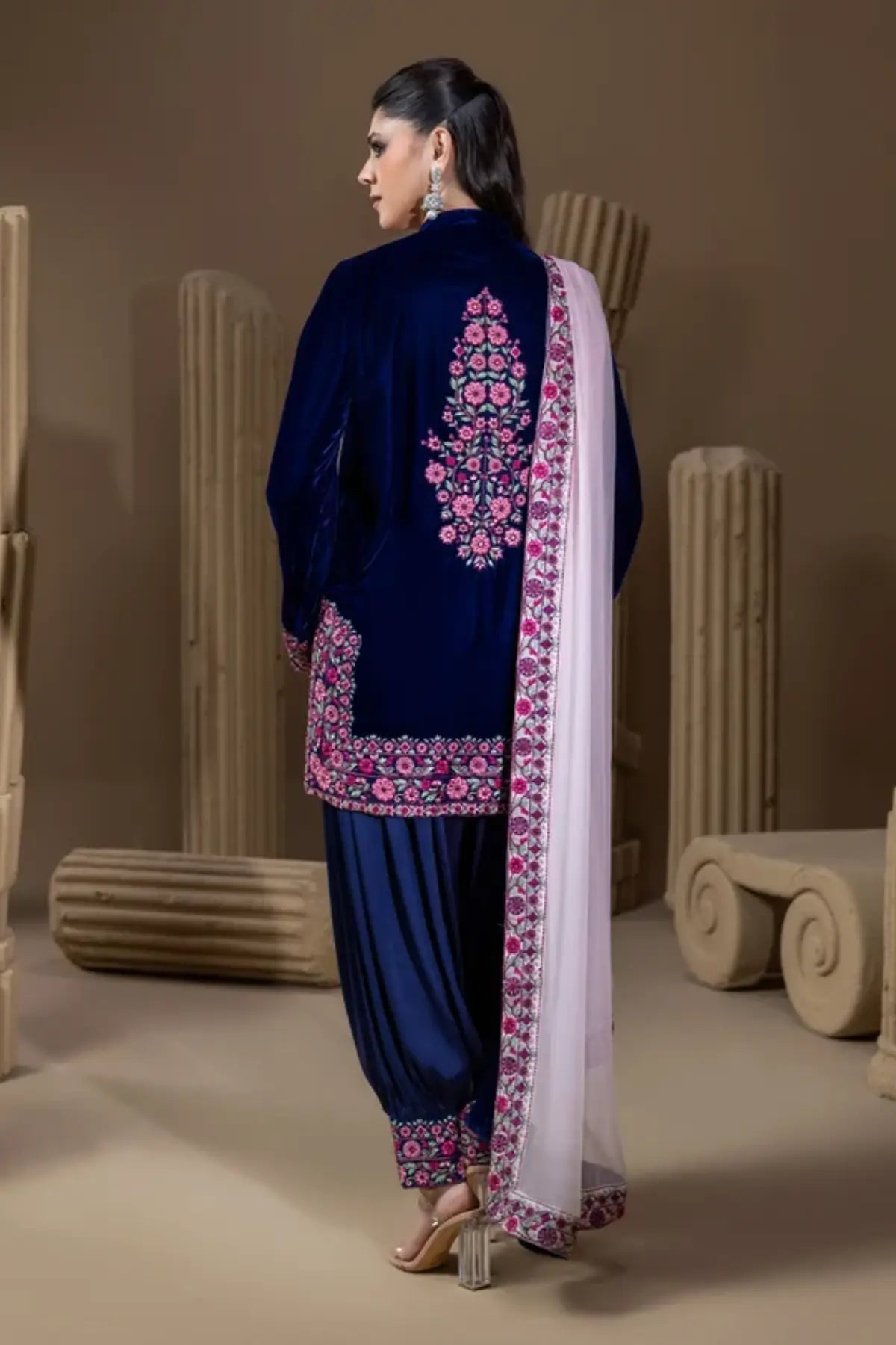 Indigo Garden midnight navy velvet stitched suit with pink resham floral embroidery, pure raw silk dhoti shalwar and chiffon dupatta.