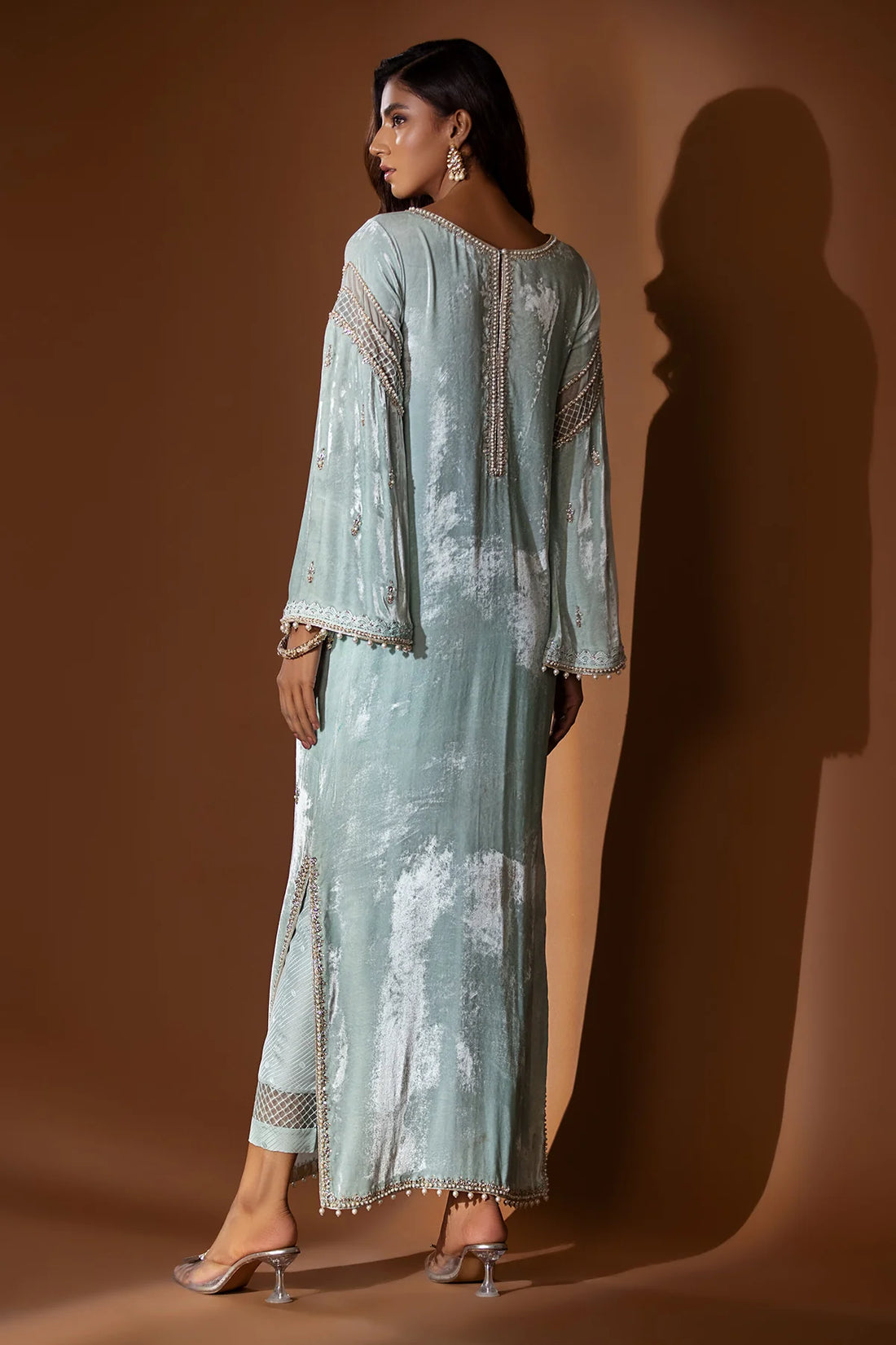 Ice blue velvet embroidered shirt with gold dabka and pearls, slit sleeves with pearl hangings, silk pants, and matching organza dupatta – formal 2025.