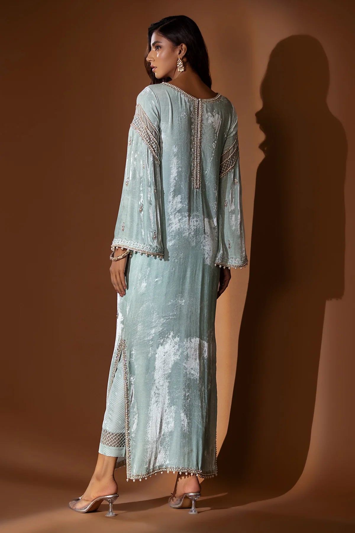 Ice blue velvet embroidered shirt with gold dabka and pearls, slit sleeves with pearl hangings, silk pants, and matching organza dupatta – formal 2025.