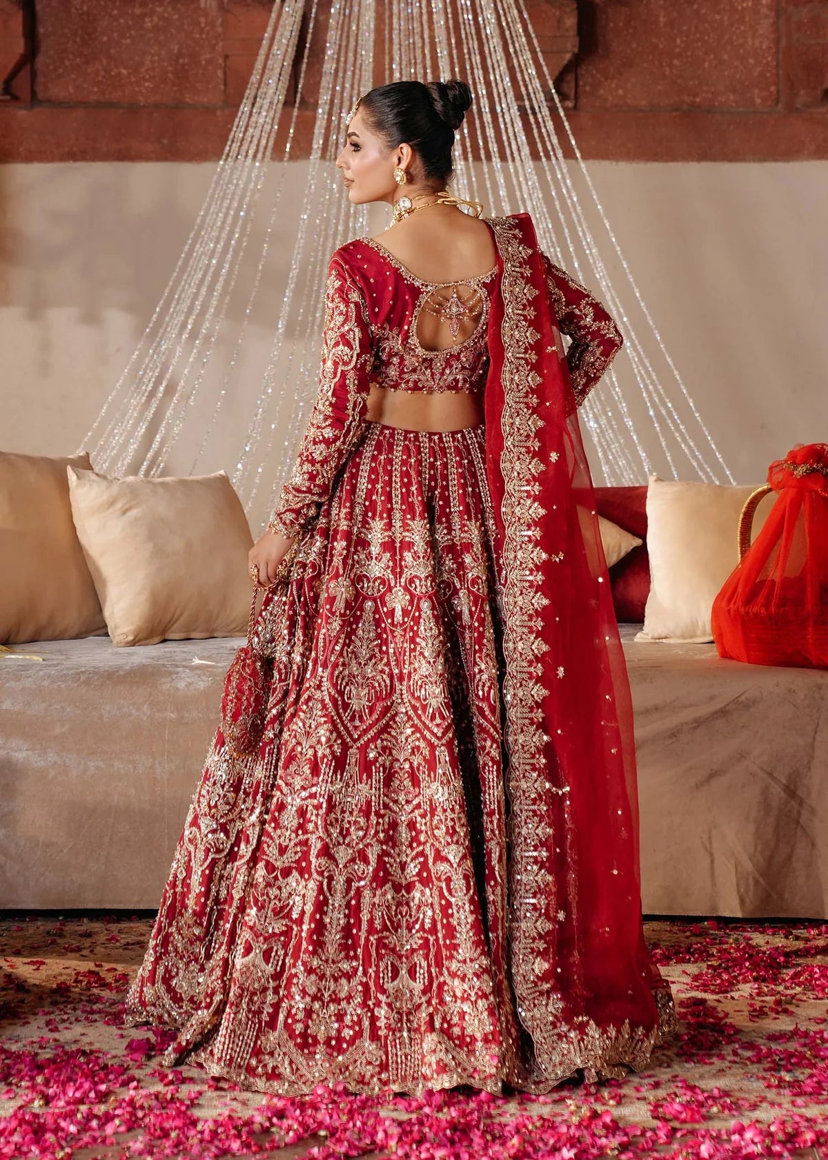 KRISHAM – Red bridal lehenga choli in Korean silk with organza dupatta and heavy embroidery. Stitched bridal outfit online at Pakistanimoda.