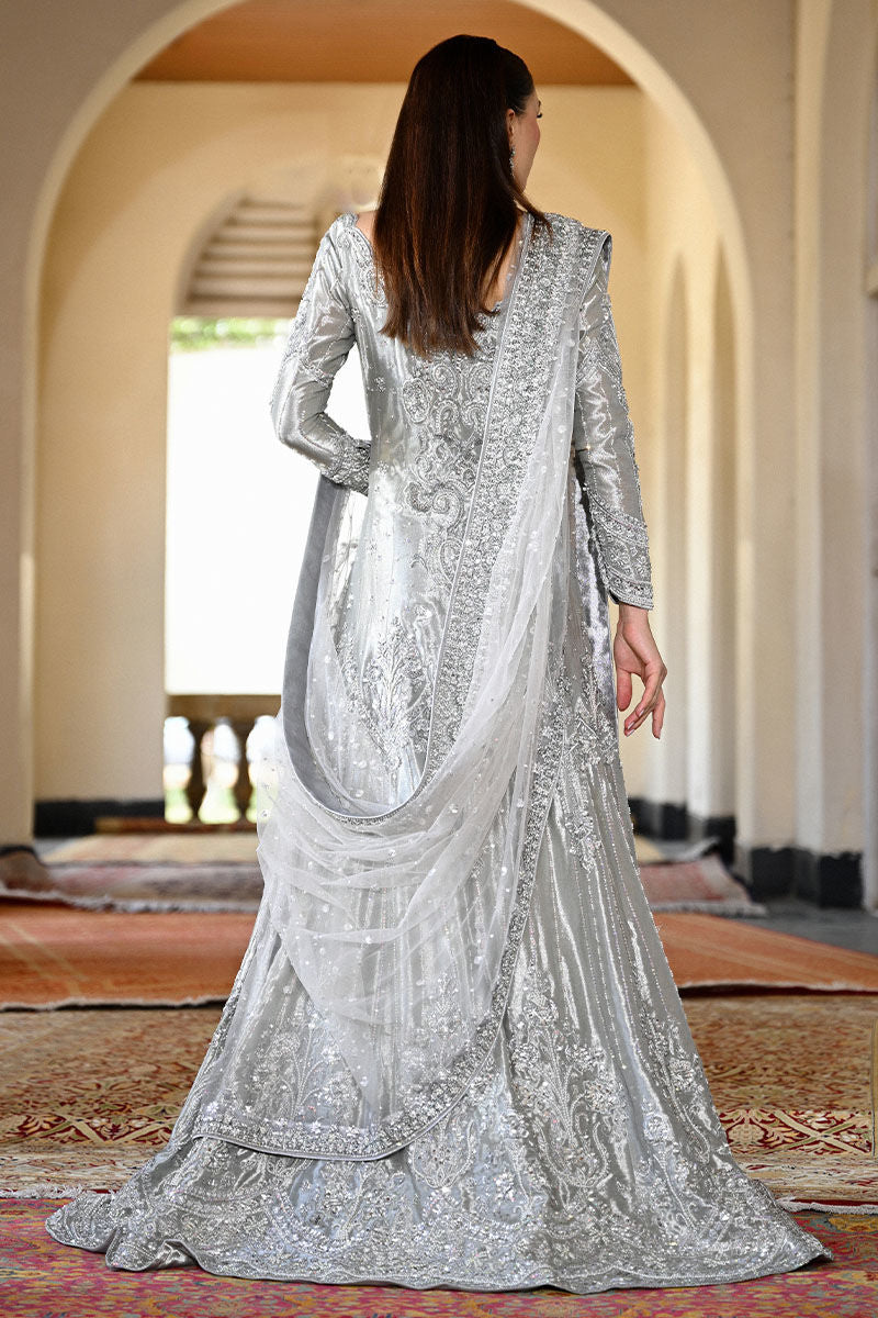 Silver Pakistani bridal mermaid gown with train, cutwork neckline, and embellished net dupatta – perfect for brides in USA, UK, and Canada.
