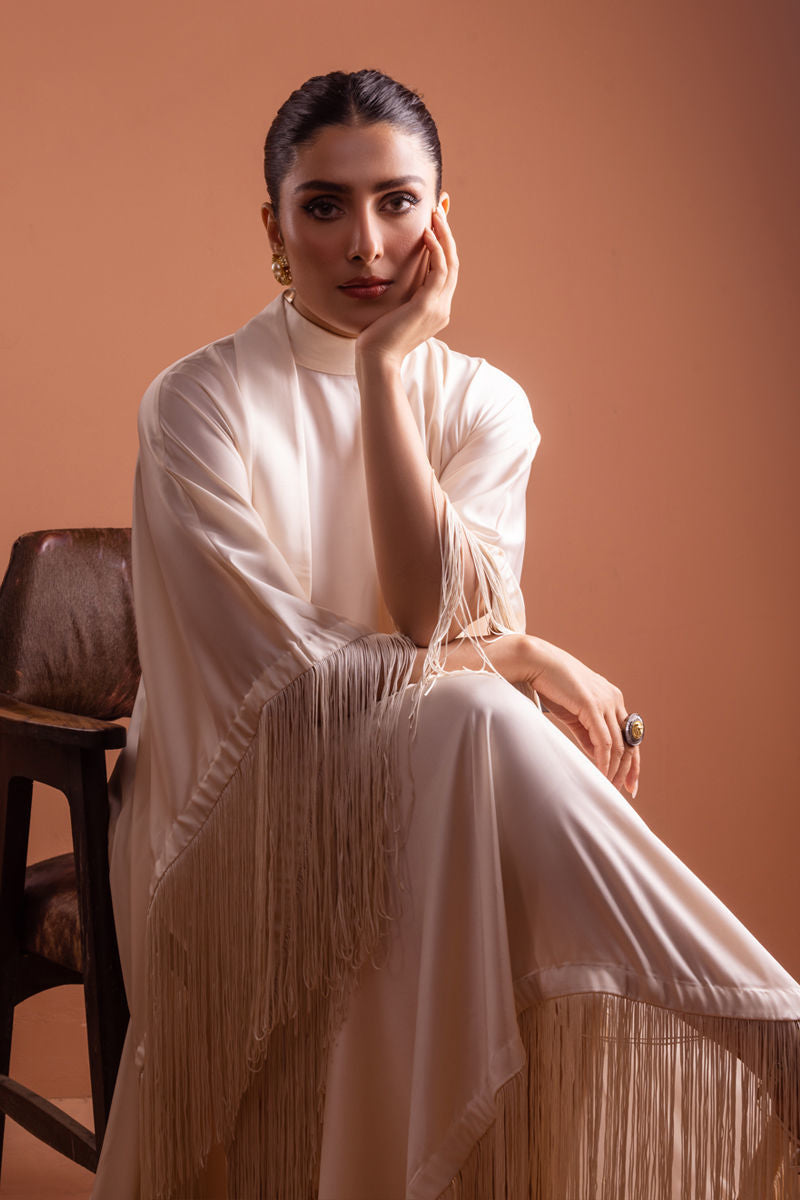 Ivory raw silk kaftan with statement tassels and neck tie design.