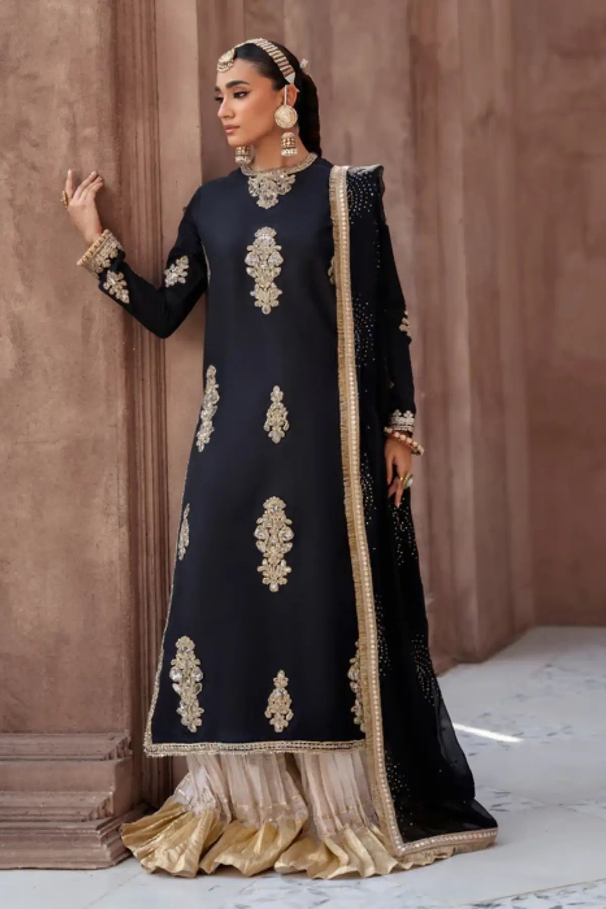 Black embroidered raw silk sharara suit by Lunia with chiffon dupatta for festive and wedding wear