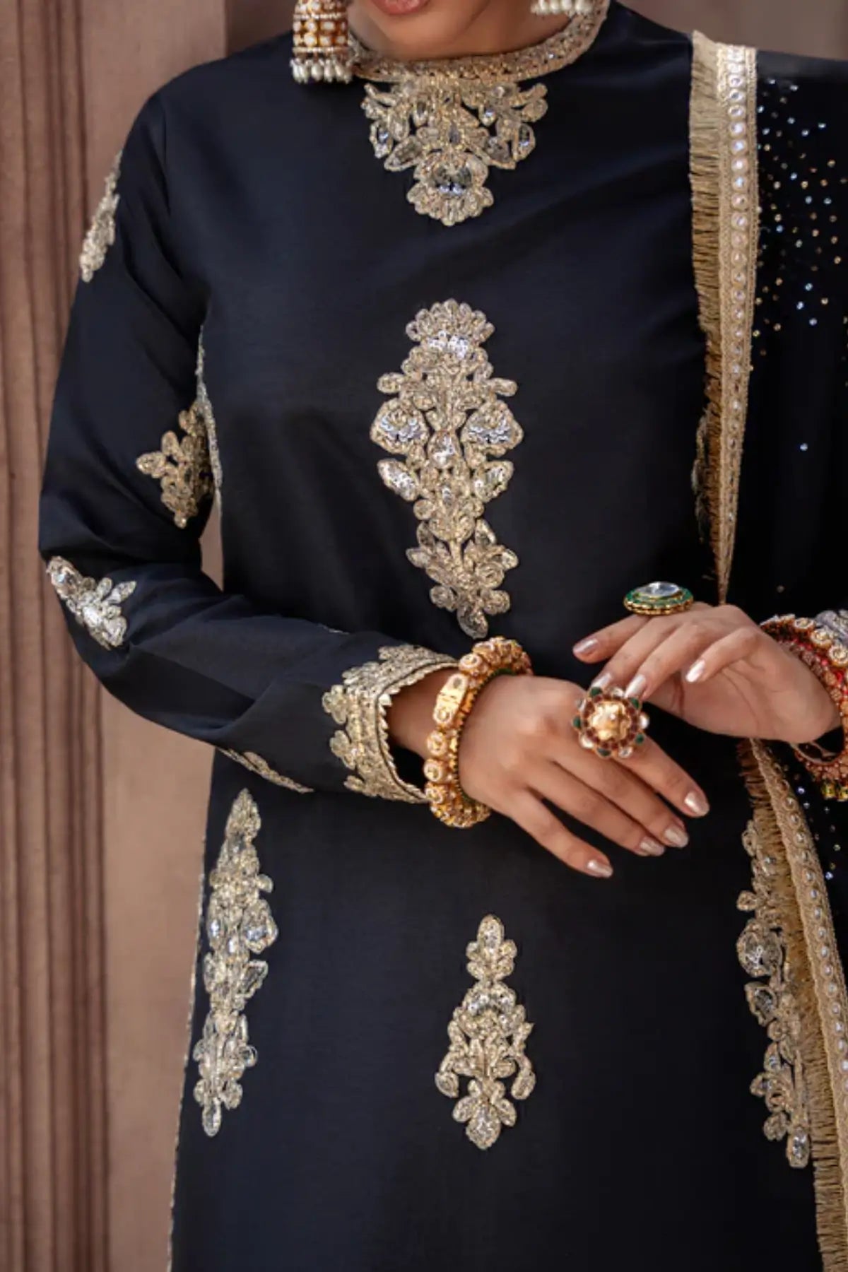 Black embroidered raw silk sharara suit by Lunia with chiffon dupatta for festive and wedding wear
